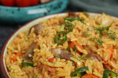 Photo of Delicious pilaf with meat on plate, closeup