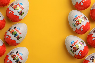 Photo of Sveti Vlas, Bulgaria - June 26, 2023: Kinder Surprise Eggs on orange background, flat lay. Space for text