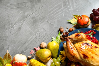 Flat lay composition with delicious turkey on grey background, space for text. Happy Thanksgiving day