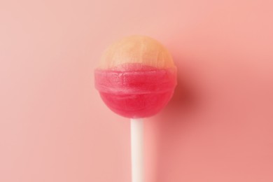 Tasty lollipop on pink background, top view