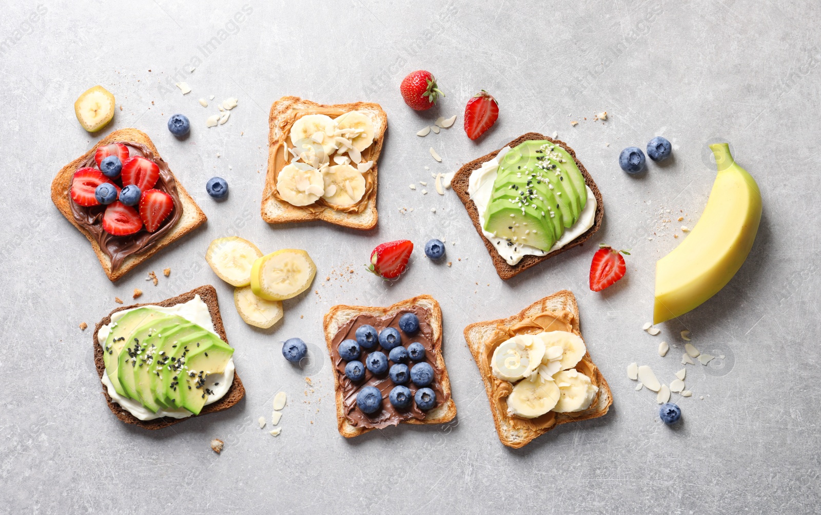 Photo of Tasty toast bread with fruits and berries on light background