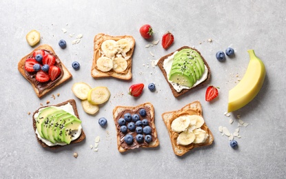 Photo of Tasty toast bread with fruits and berries on light background