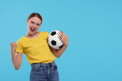 Photo of Emotional fan holding football ball and celebrating on light blue background, space for text