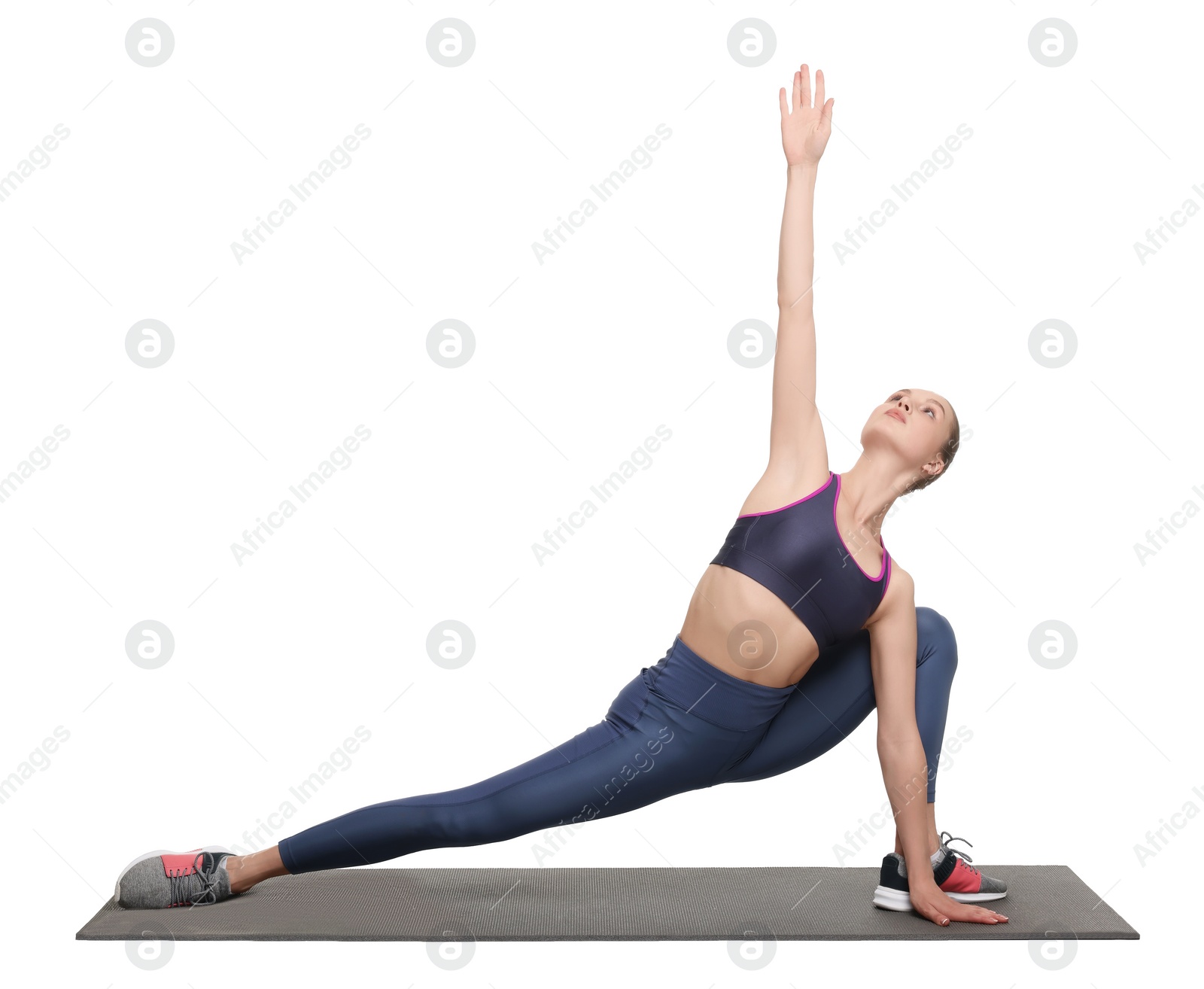 Photo of Yoga workout. Young woman stretching on white background