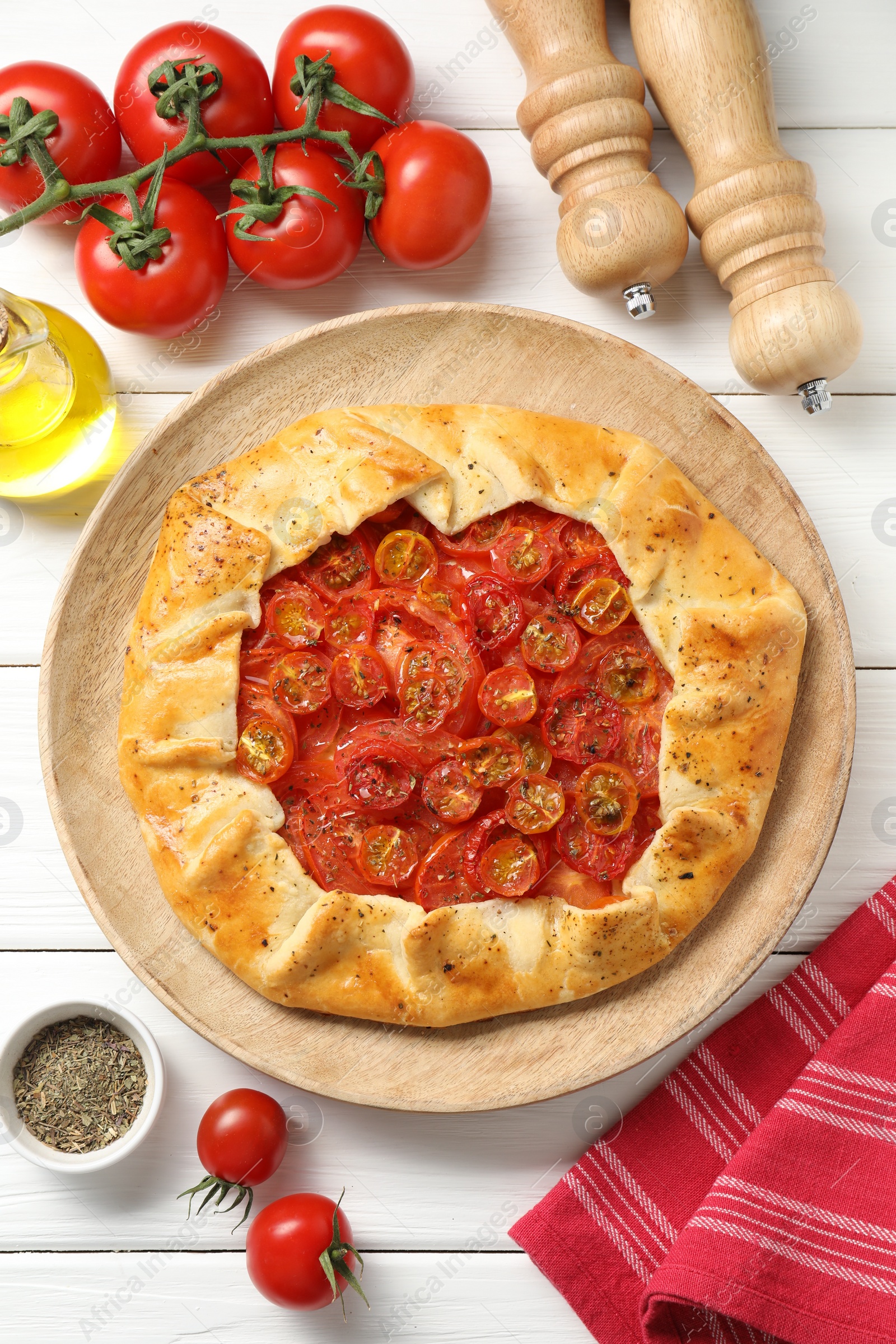 Photo of Flat lay composition with tasty tomato galette (Caprese galette) on white wooden table