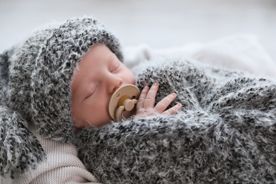 Cute newborn baby sleeping on plaid, closeup