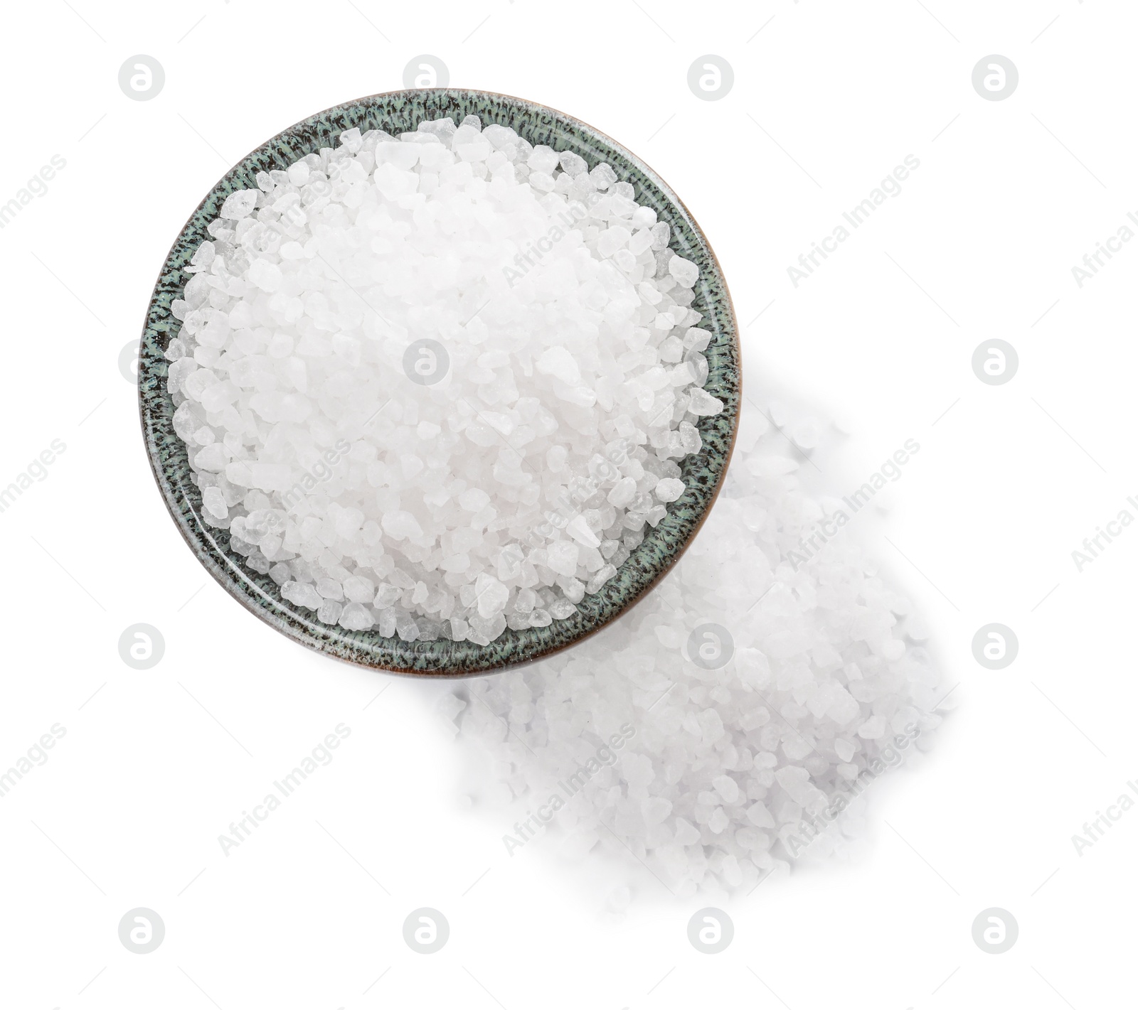 Photo of Ceramic bowl and heap of natural sea salt isolated on white, top view