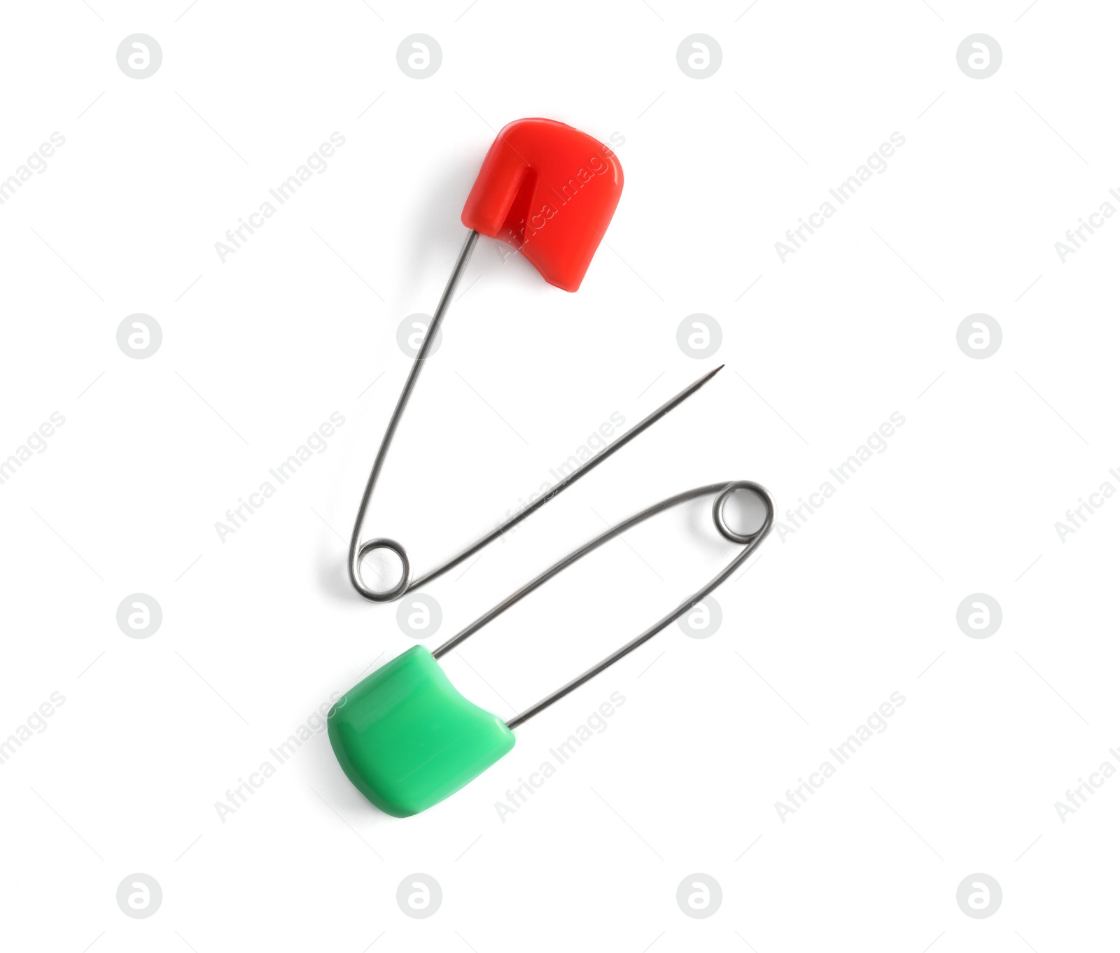 Photo of Colorful safety pins on white background, flat lay