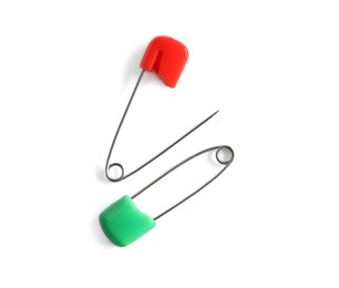Photo of Colorful safety pins on white background, flat lay