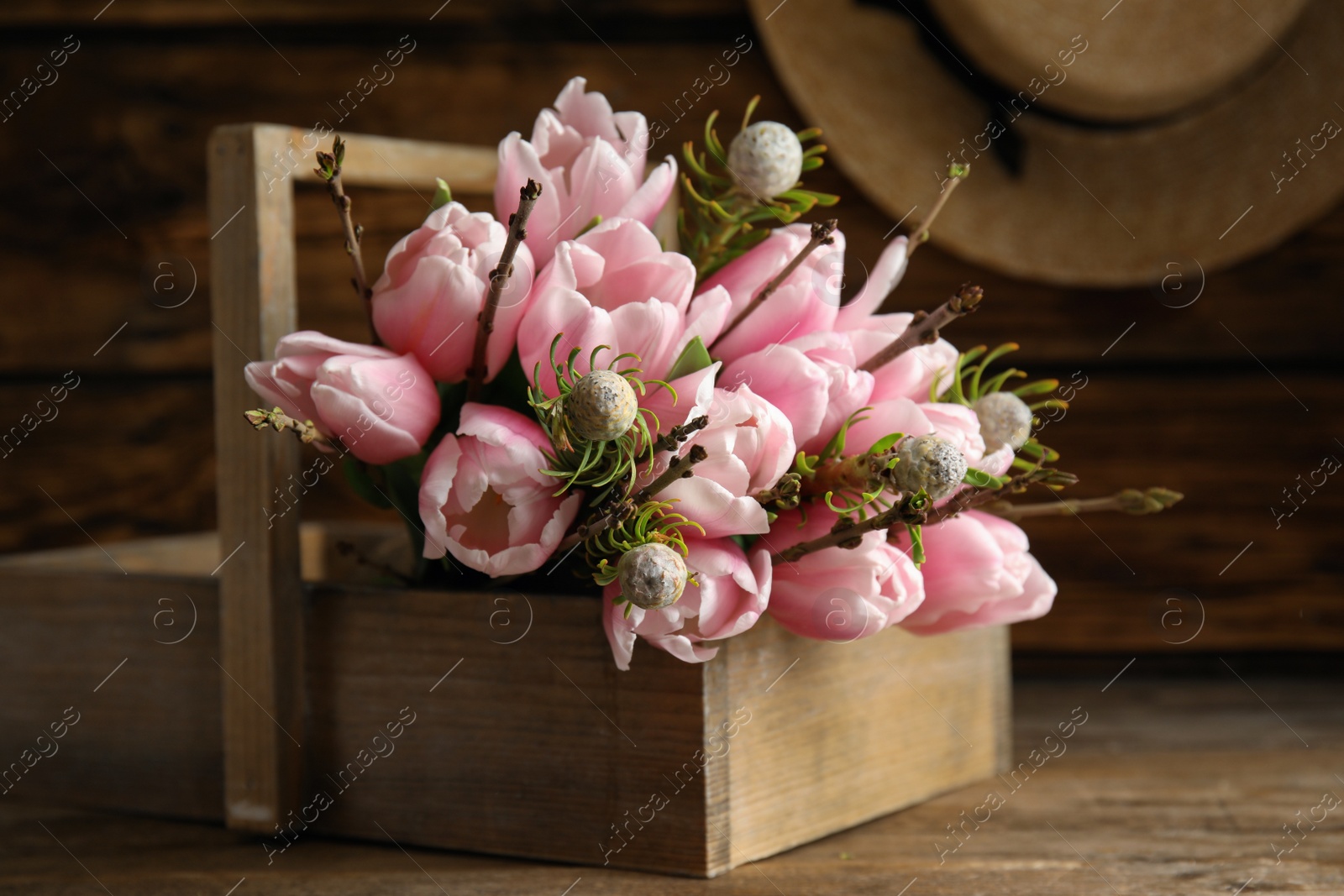 Photo of Beautiful bouquet of spring pink tulips on wooden table