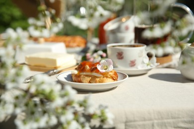 Beautiful table setting in spring garden on sunny day