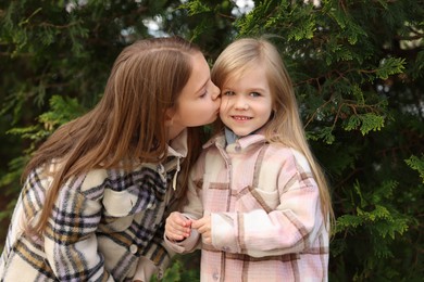 Photo of Cute little sisters spending time together outdoors