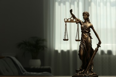Photo of Figure of Lady Justice indoors, space for text. Symbol of fair treatment under law