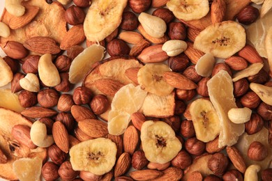 Photo of Different tasty nuts and dried fruits as background, top view