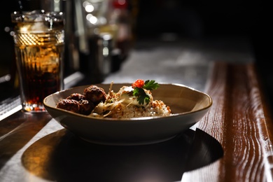 Photo of Plate with rice and meat balls served on table