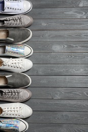 Photo of Flat lay composition with stylish shoes and space for text on wooden background