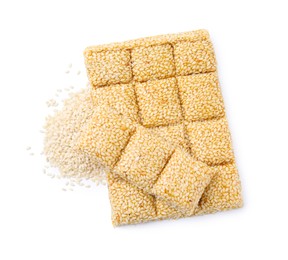 Tasty sweet kozinaki bars and sesame seeds on white background, top view