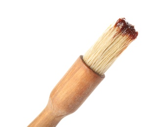 Basting brush with barbecue sauce on white background