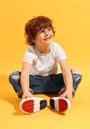 Photo of Fashion concept. Stylish boy posing on yellow background