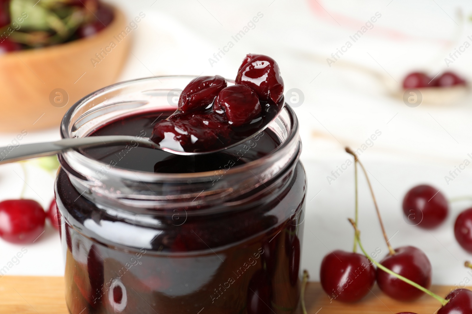 Photo of Jar of delicious pickled cherries, closeup view