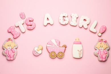 Phrase IT IS A GIRL and tasty cookies on pink background, flat lay. Baby shower party