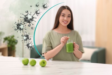 Happy woman with immunity boosting cocktail in kitchen. Protection against viruses