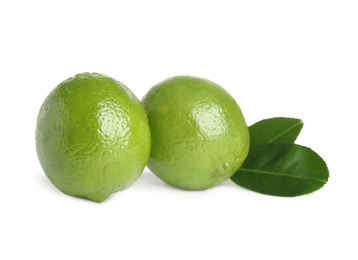 Photo of Fresh ripe limes with green leaves isolated on white