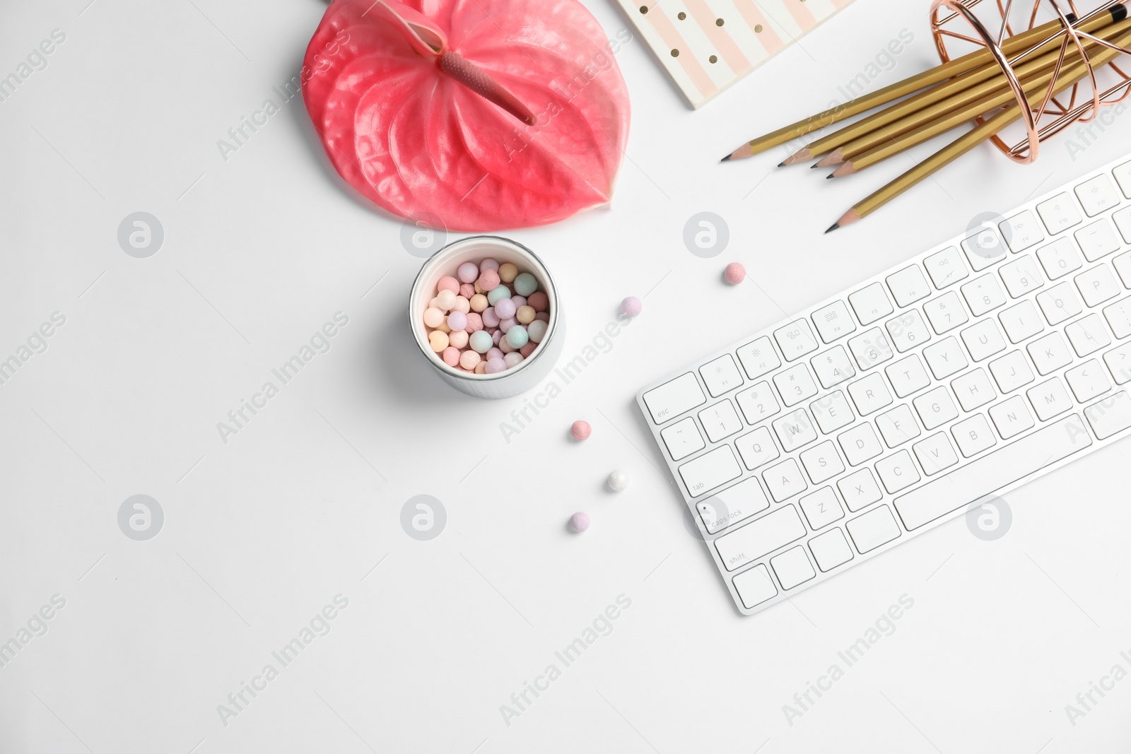 Photo of Creative flat lay composition with tropical flower, stationery and computer keyboard on white background