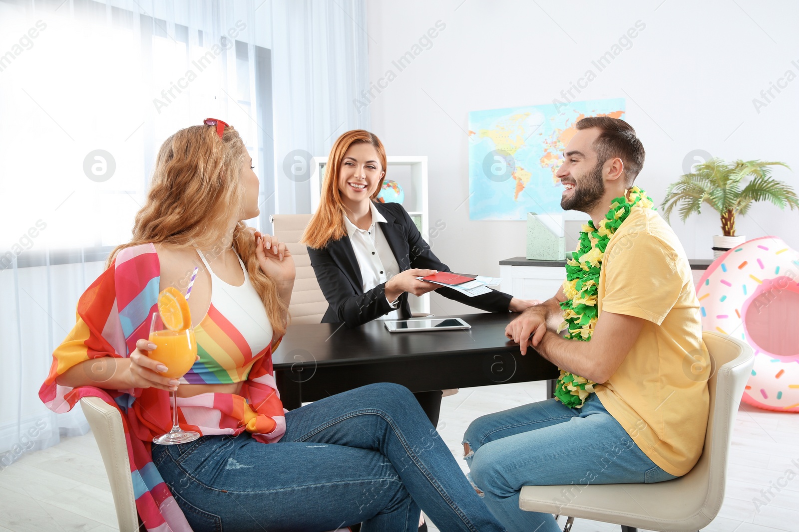 Photo of Beautiful young couple visiting travel agency office