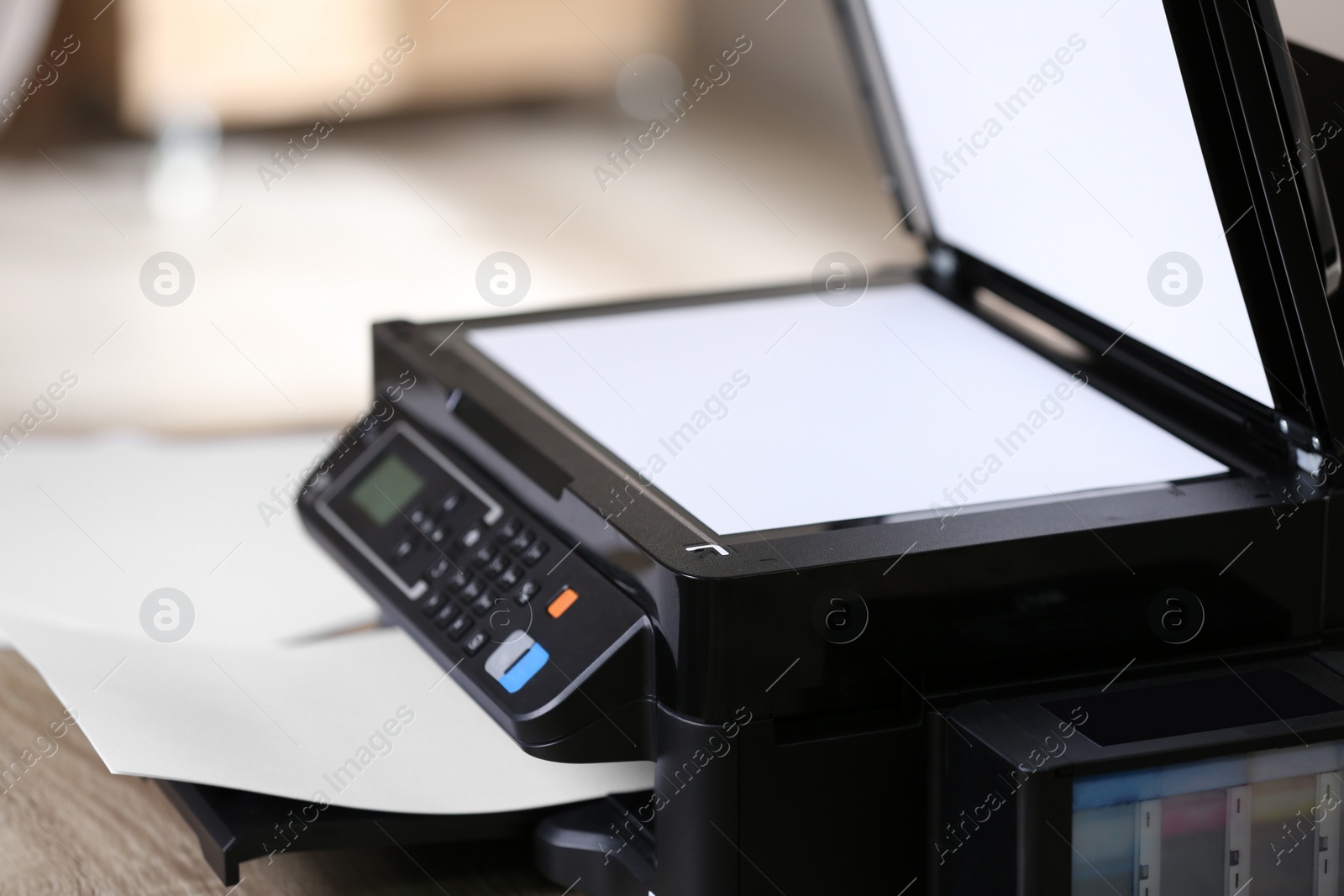 Photo of New modern multifunction printer on table indoors, closeup