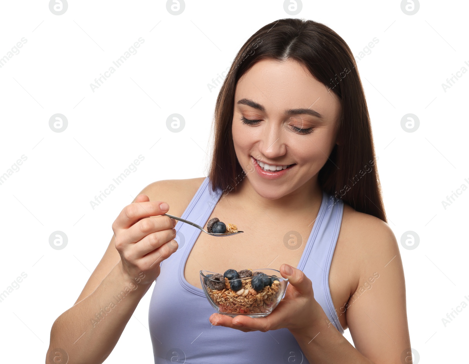 Photo of Happy woman eating tasty granola with fresh berries on white background