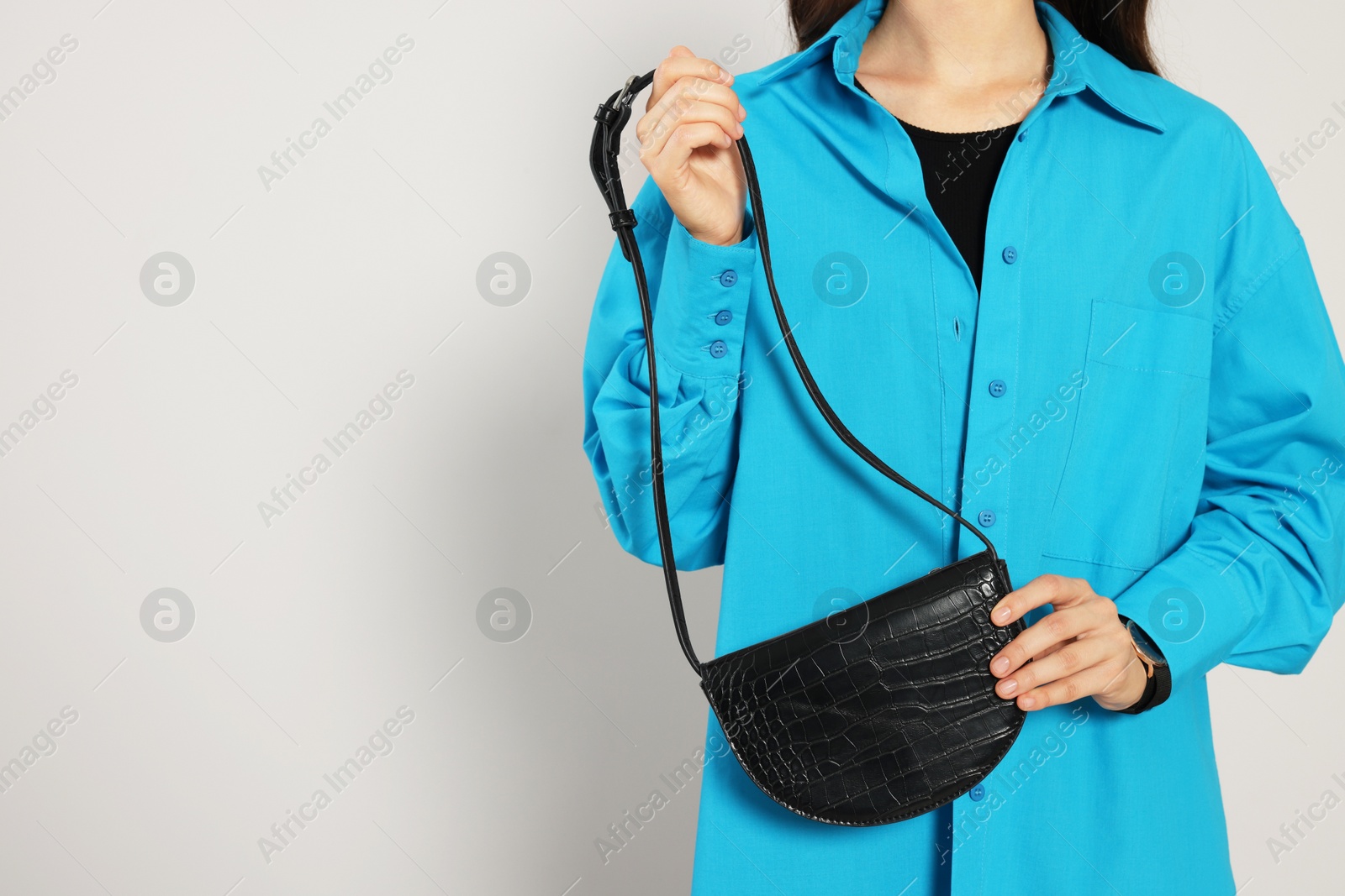 Photo of Woman with stylish bag on white background, closeup. Space for text