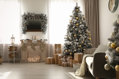 Stylish Christmas interior with beautiful decorated tree and fireplace