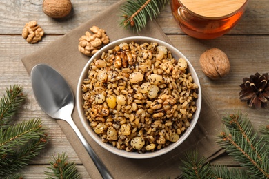 Photo of Traditional Christmas slavic dish kutia served on wooden table, flat lay