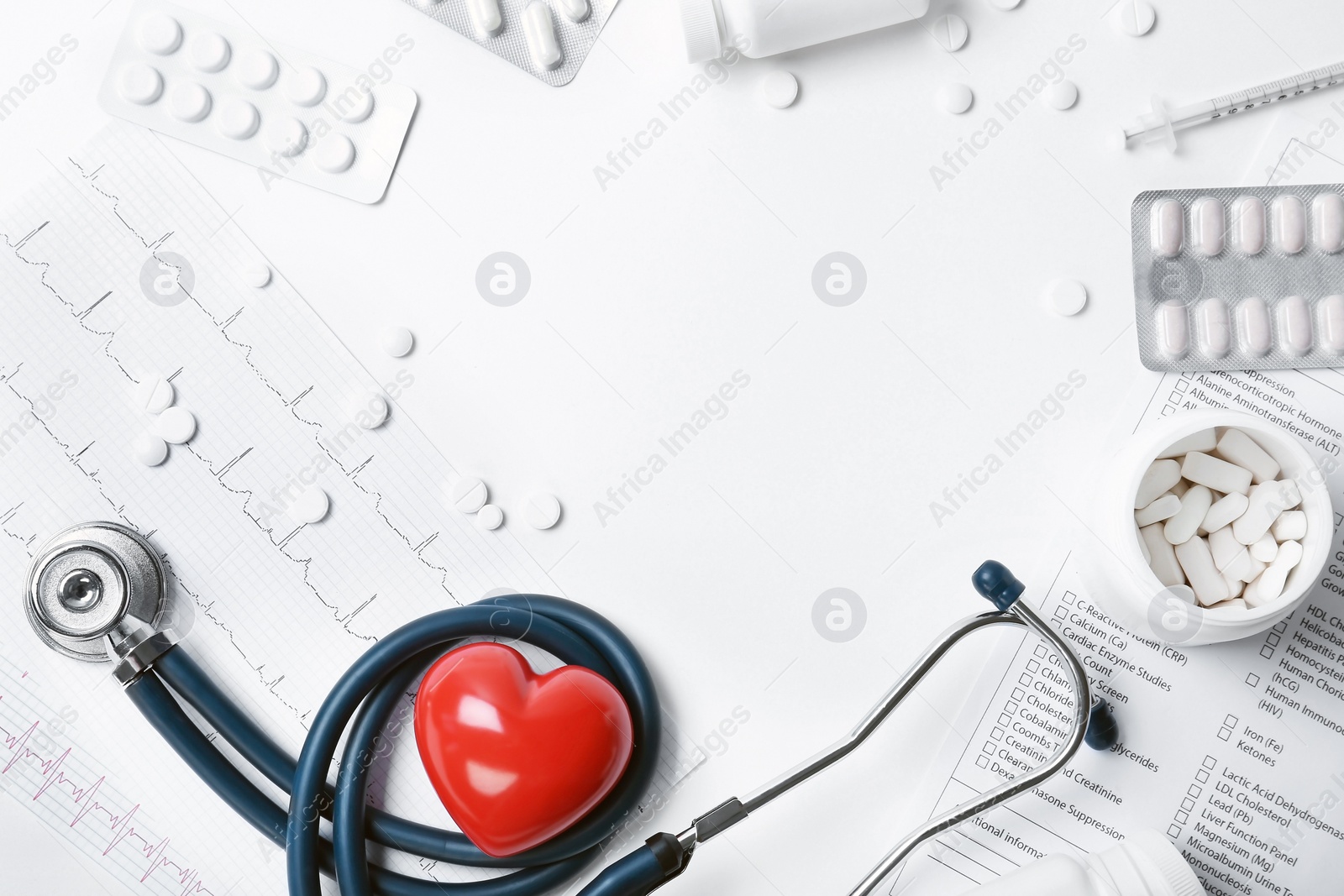 Photo of Composition with stethoscope and pills on white background. Cardiology service