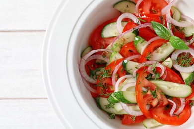 Photo of Plate with delicious fresh salad on table, top view