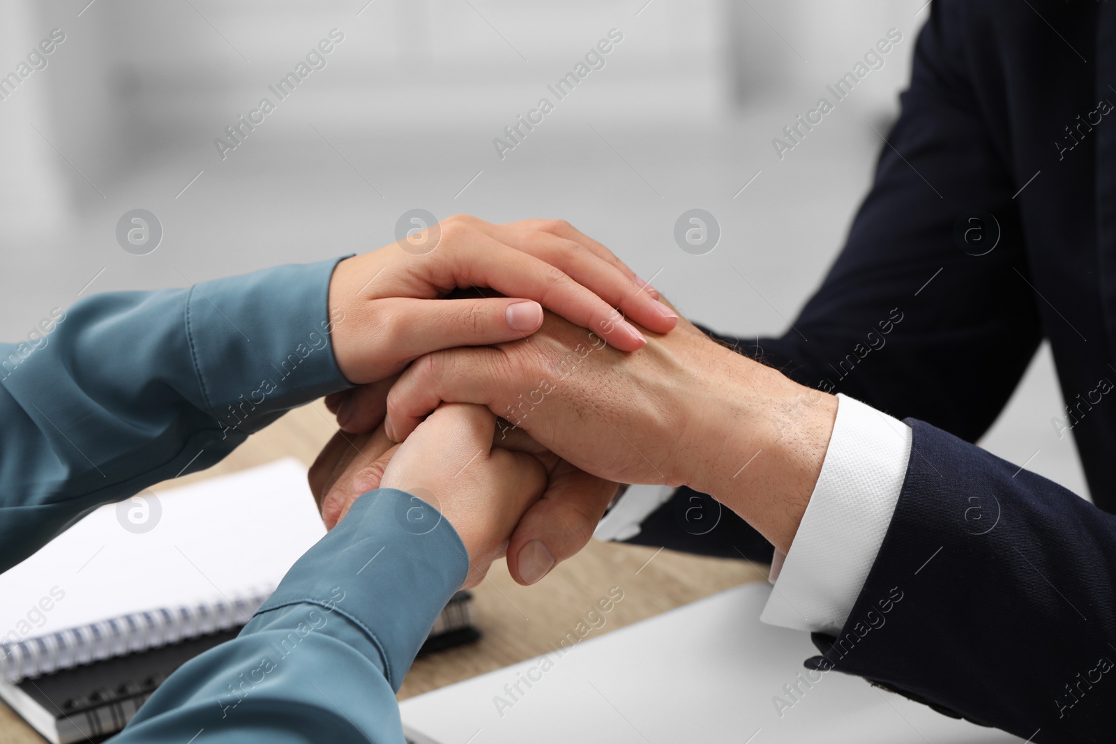 Photo of Trust and deal. Woman with man joining hands indoors, closeup