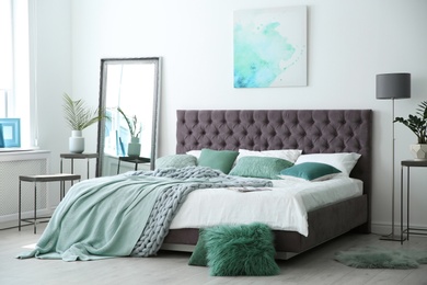 Stylish bedroom interior with mint decor elements