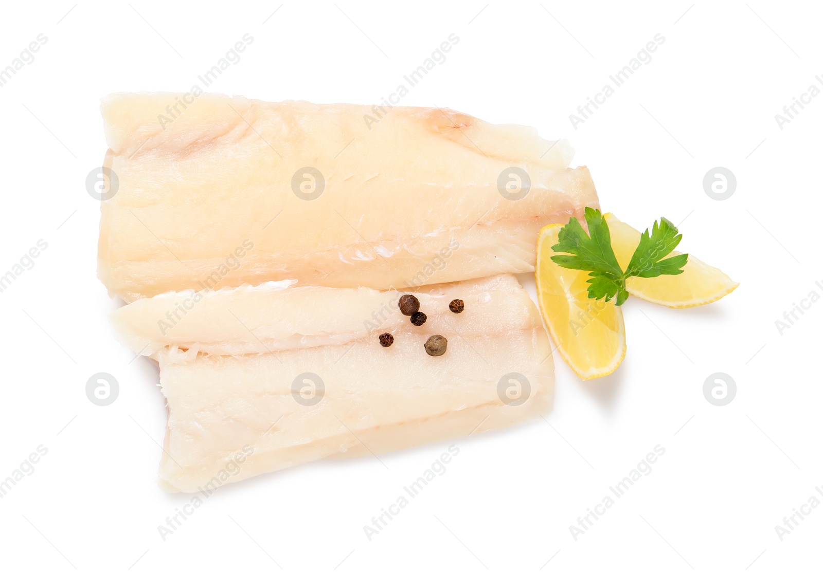 Photo of Pieces of raw cod fish, parsley, peppercorns and lemon isolated on white, top view