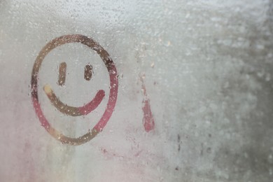 Photo of Happy face drawn on foggy window, space for text. Rainy weather