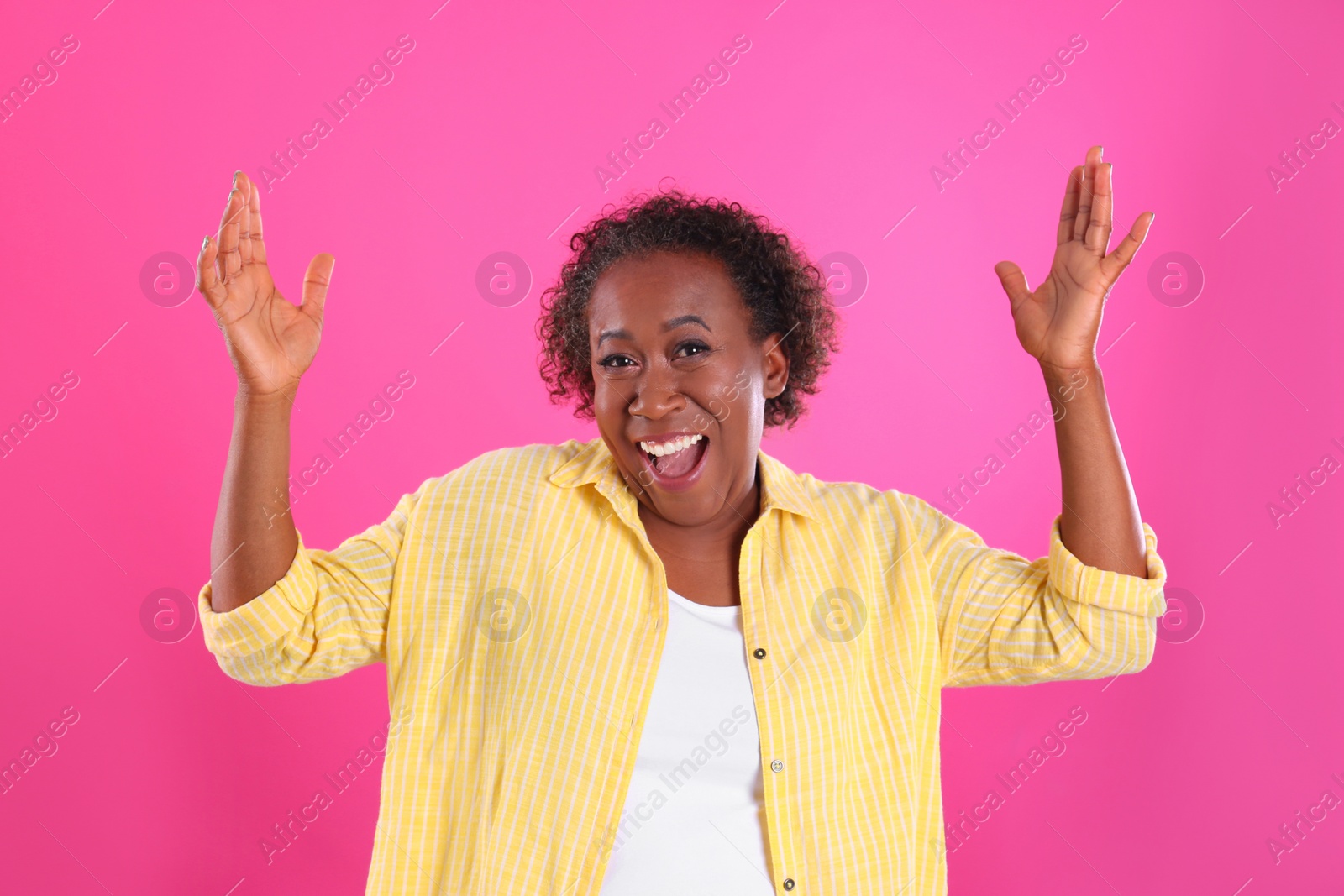 Photo of Portrait of happy African-American woman on pink background