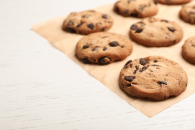 Photo of Tasty chocolate cookies on light table, closeup