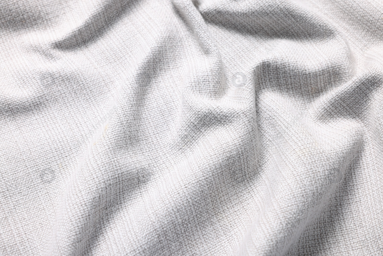 Photo of Texture of white crumpled fabric as background, closeup