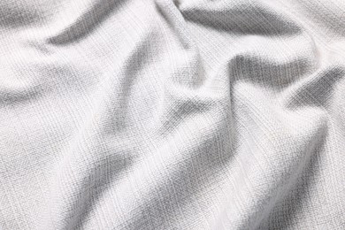 Photo of Texture of white crumpled fabric as background, closeup