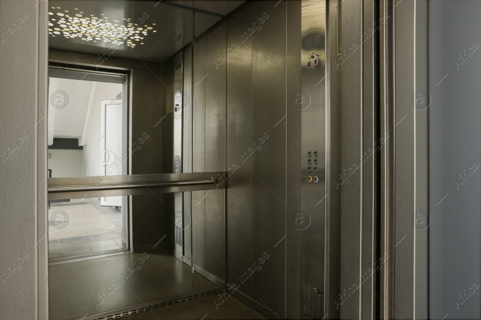 Photo of Open elevator`s cabin with big mirror indoors