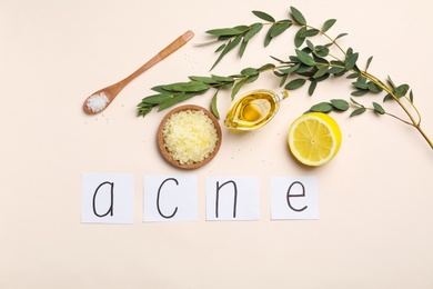 Word "Acne" and ingredients for homemade effective problem skin remedies on light background, flat lay
