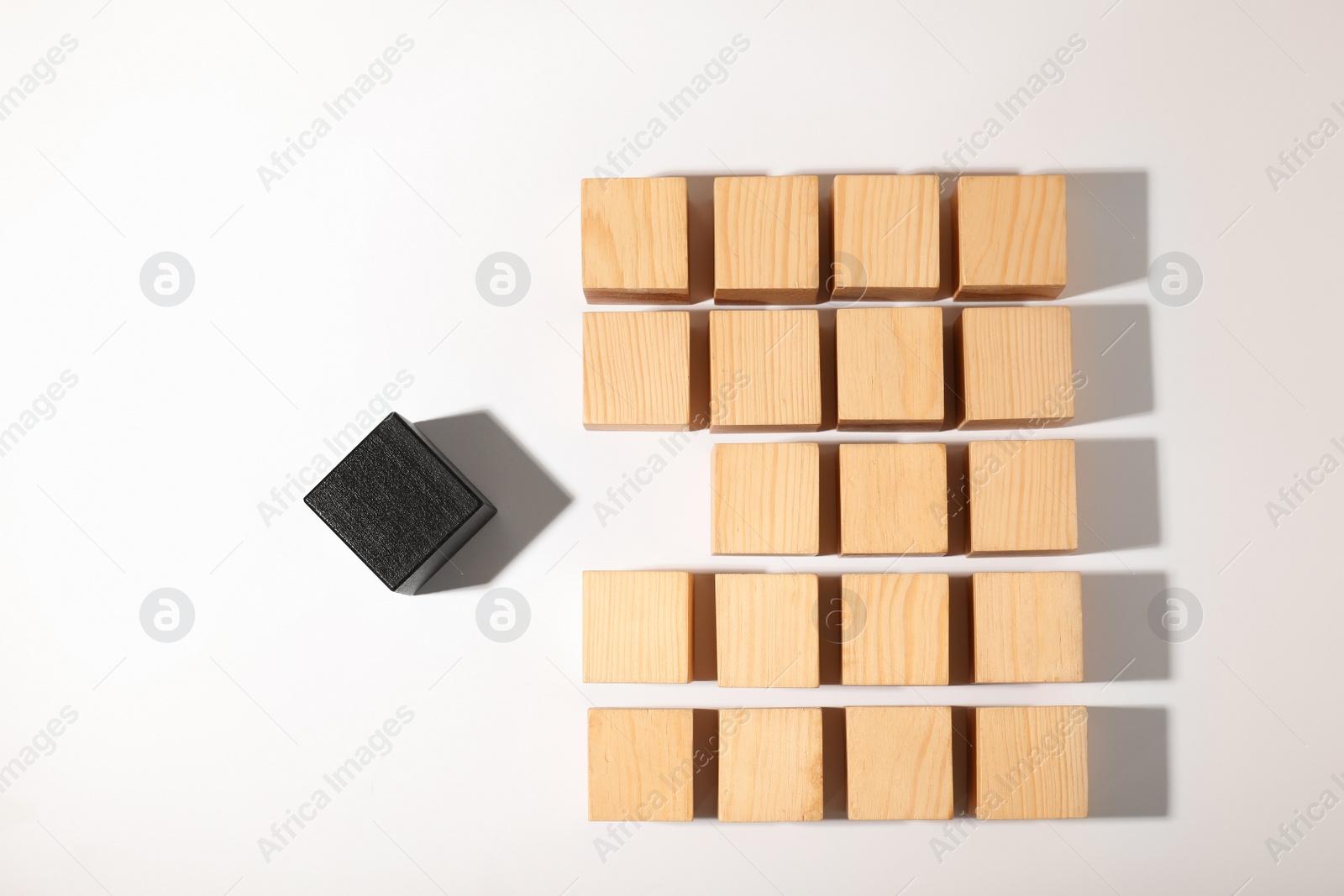 Photo of One different cube standing out from others on white background, top view