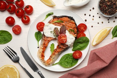 Tasty salmon steak served on white wooden table, flat lay