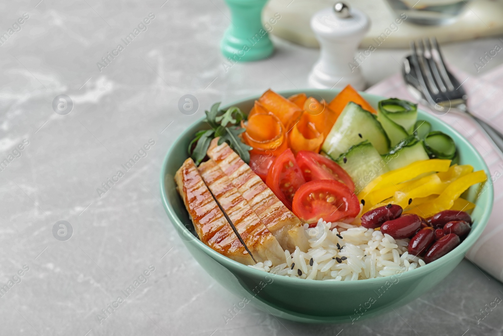 Photo of Tasty rice with beans and chicken meat on light grey marble table