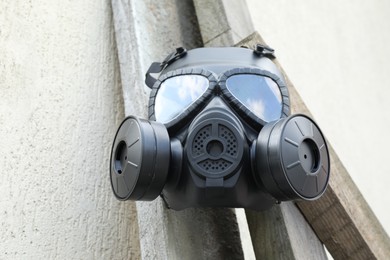 Photo of One gas mask hanging on building outdoors, low angle view